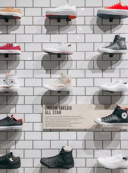 A selection of Chuck Taylor sneakers displayed on a tiled wall in a store.