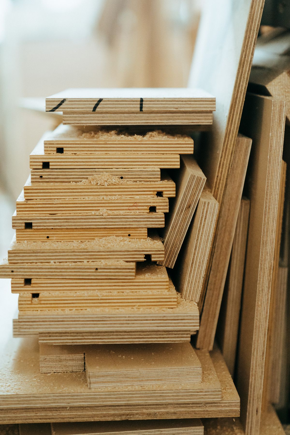 Stacked plywood sheets ready for engineered kitchen manufacturing at Paramount Kitchen, Kangra