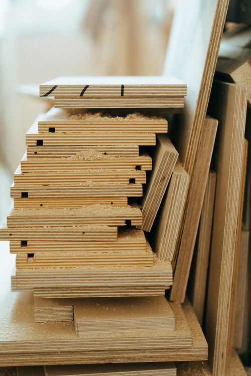 Free Close-up of stacked plywood sheets in a workshop, showcasing woodworking materials and textures. Stock Photo