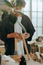 Man in Black Long Sleeve Shirt Holding Brown Wooden Stick