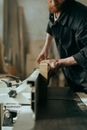 Man in Black Button Up Shirt Holding Brown Wooden Board