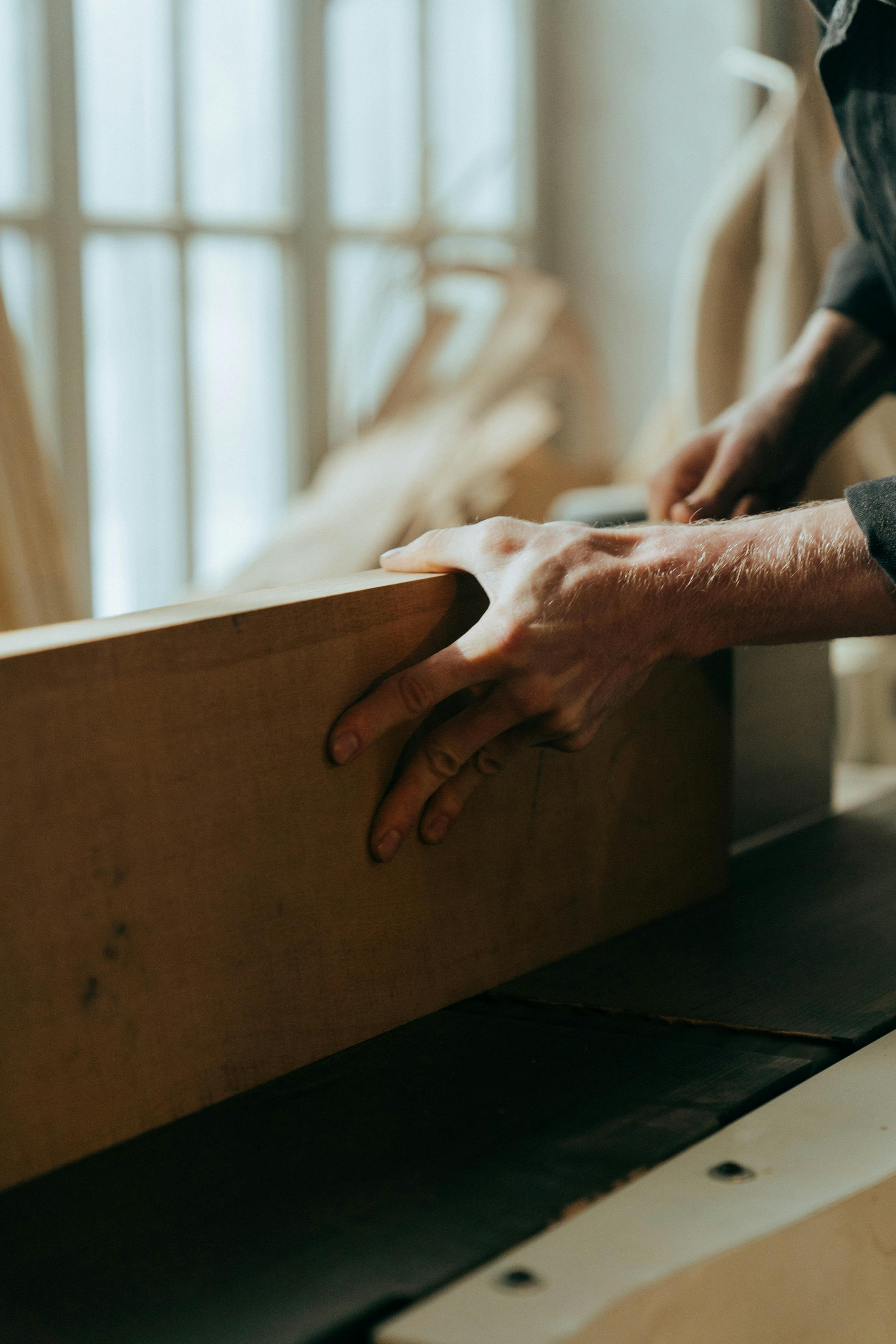 person holding brown wooden board