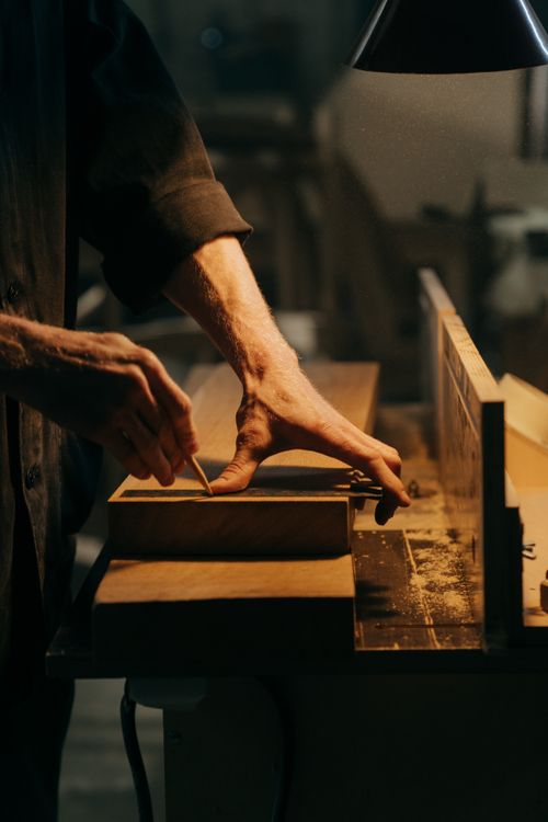 Close-up of hands planing a wooden board