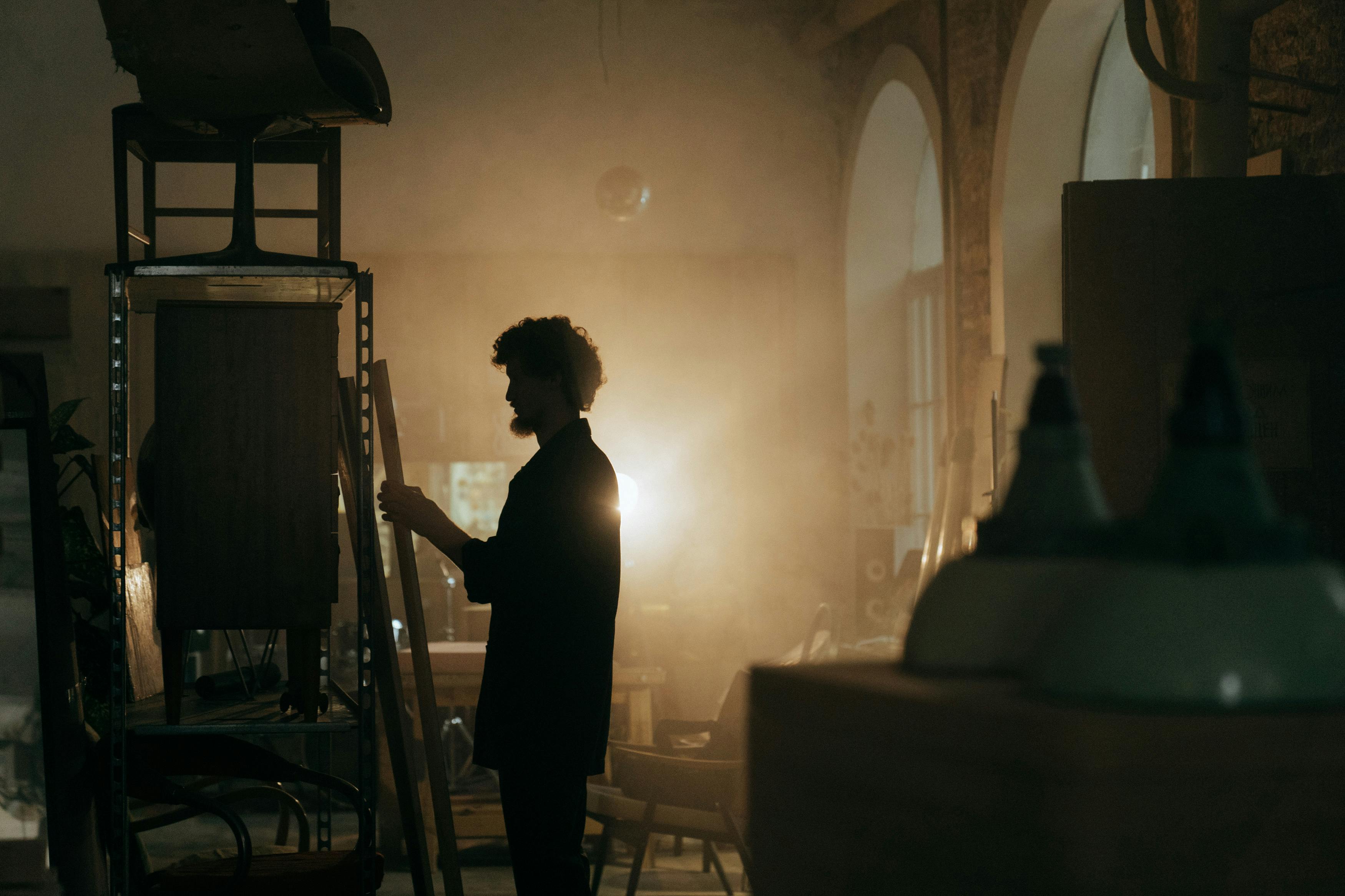 silhouette of woman standing near brown wooden table