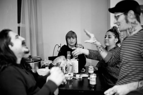 Grayscale Photo of People Drinking Together