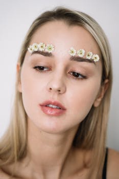 Intimate portrait of a woman with floral eyebrow makeup, showcasing an artistic and natural look.