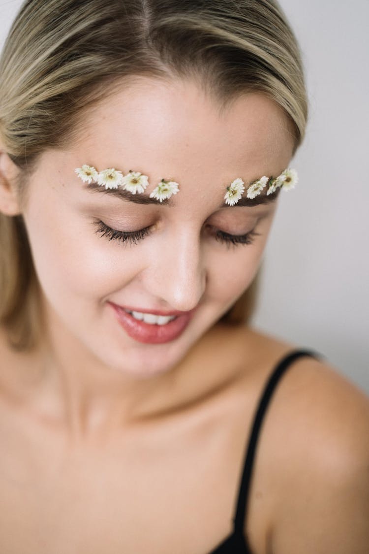 A Woman With Small Flowers Over Her Eyebrows