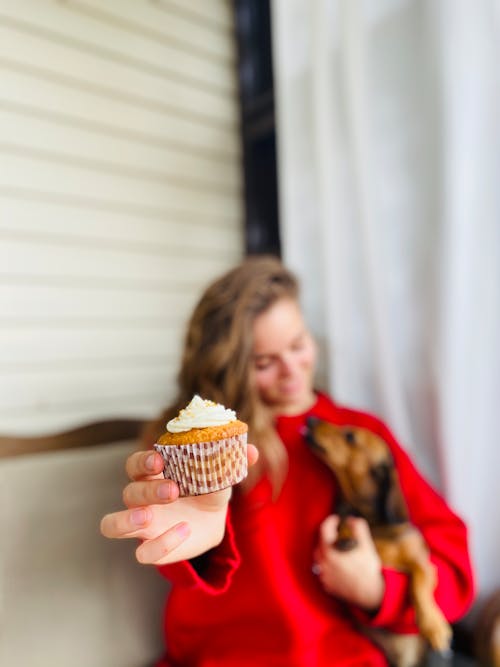 A Woman Holding a Cupcake