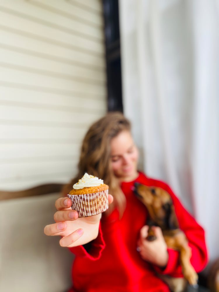 A Woman Holding A Cupcake