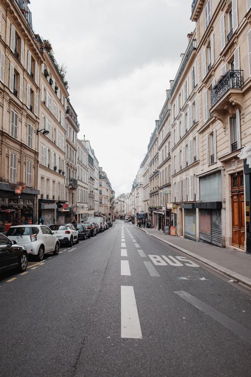 Free Discover the elegance of a classic Parisian street lined with historic buildings on a cloudy day. Stock Photo