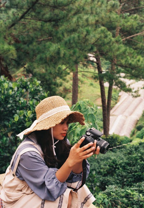 Woman Wearing a Hat Holding a Camera