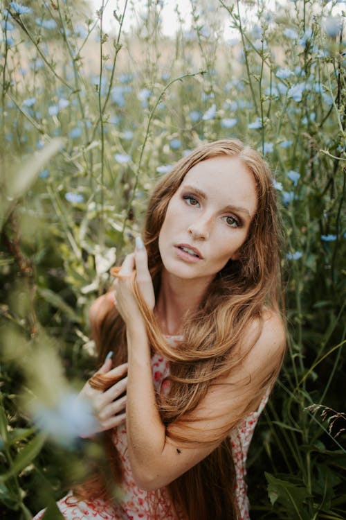 Woman with Long Hair in the Middle of a Flower Field