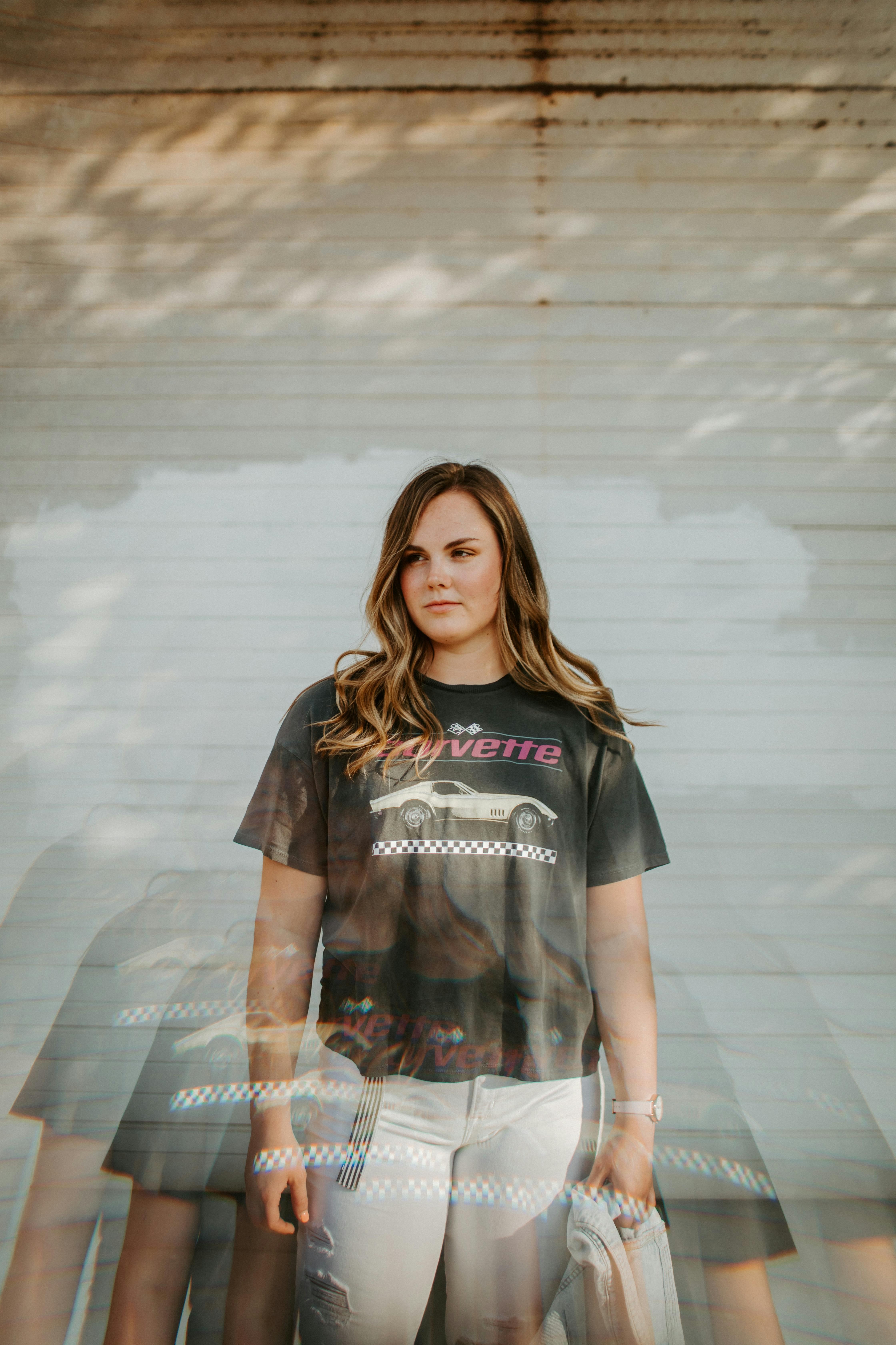 Portrait of a stylish woman in a graphic t-shirt with a creative multi-exposure effect.