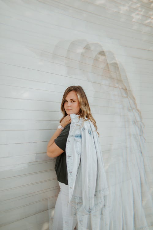 Woman Holding a Denim Jacket