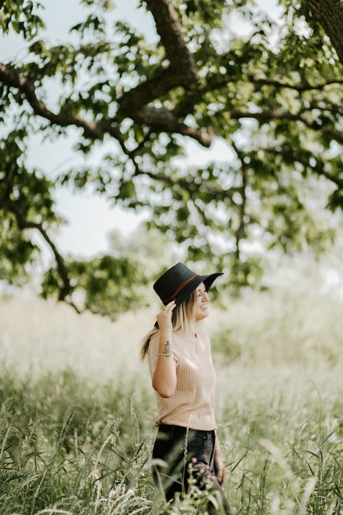 Woman Standing on Grass Field