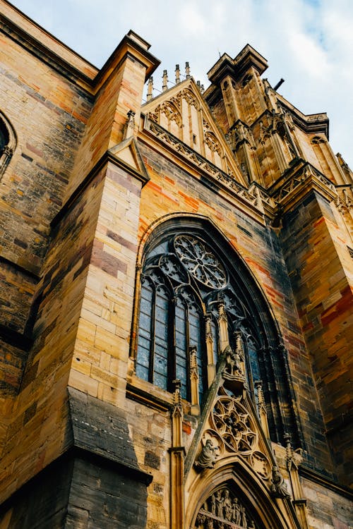 Facade of medieval tower with arched window