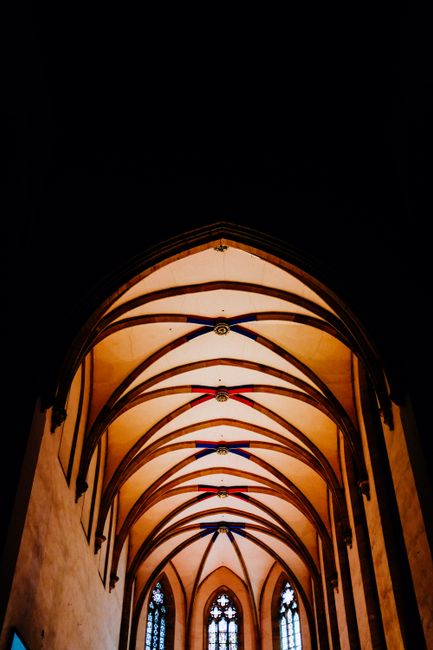 From below of catholic cathedral with arched entrance and round shaped ceiling with geometrical elements
