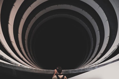 Back View Shot of a Man Peeking on a Spiral Tunnel