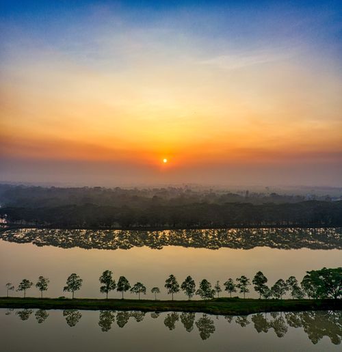 Free A breathtaking sunrise over a reflective river in Serang, Indonesia. Perfect harmony of nature's beauty. Stock Photo