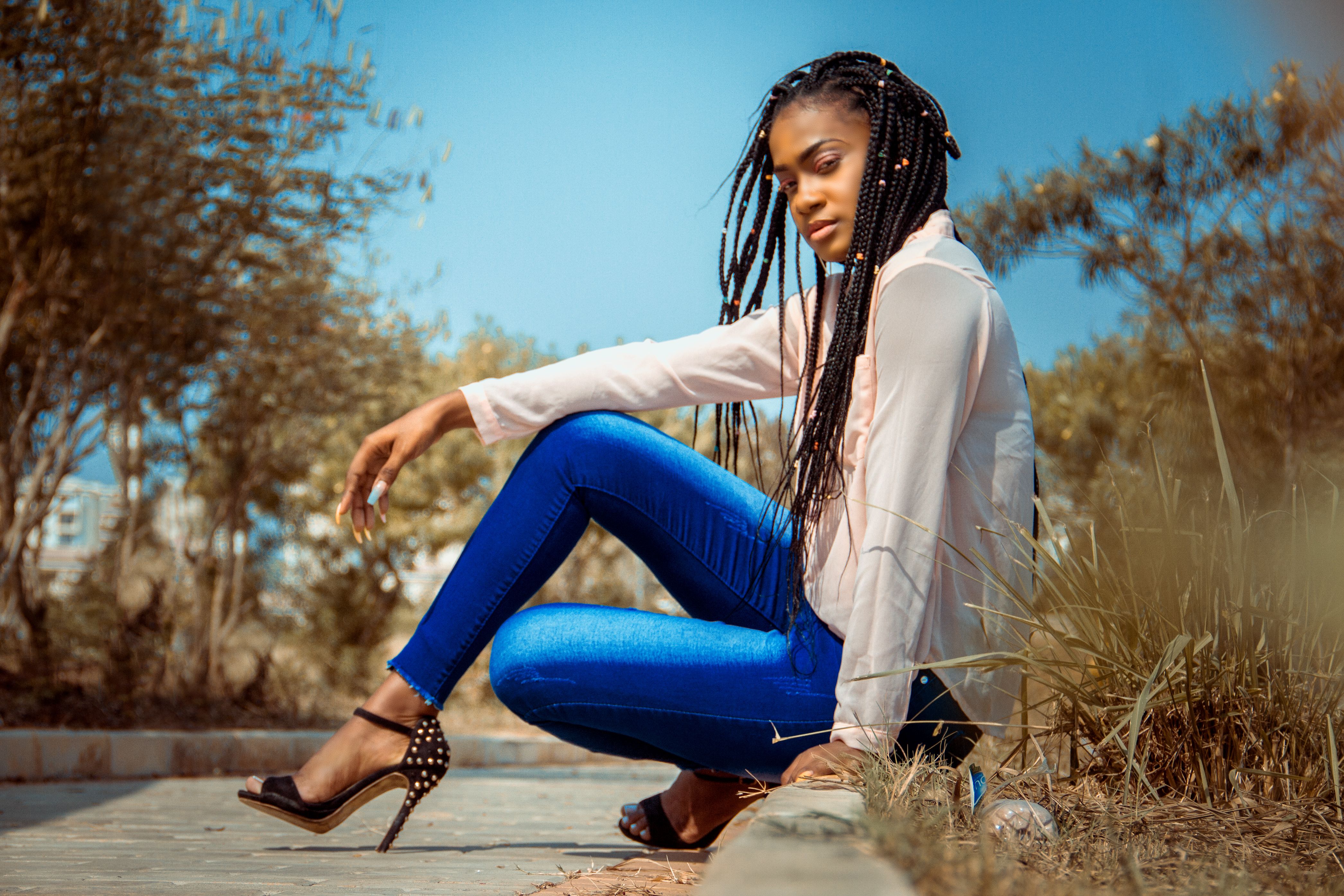 Stylish black woman in bright jeans on city street · Free Stock Photo