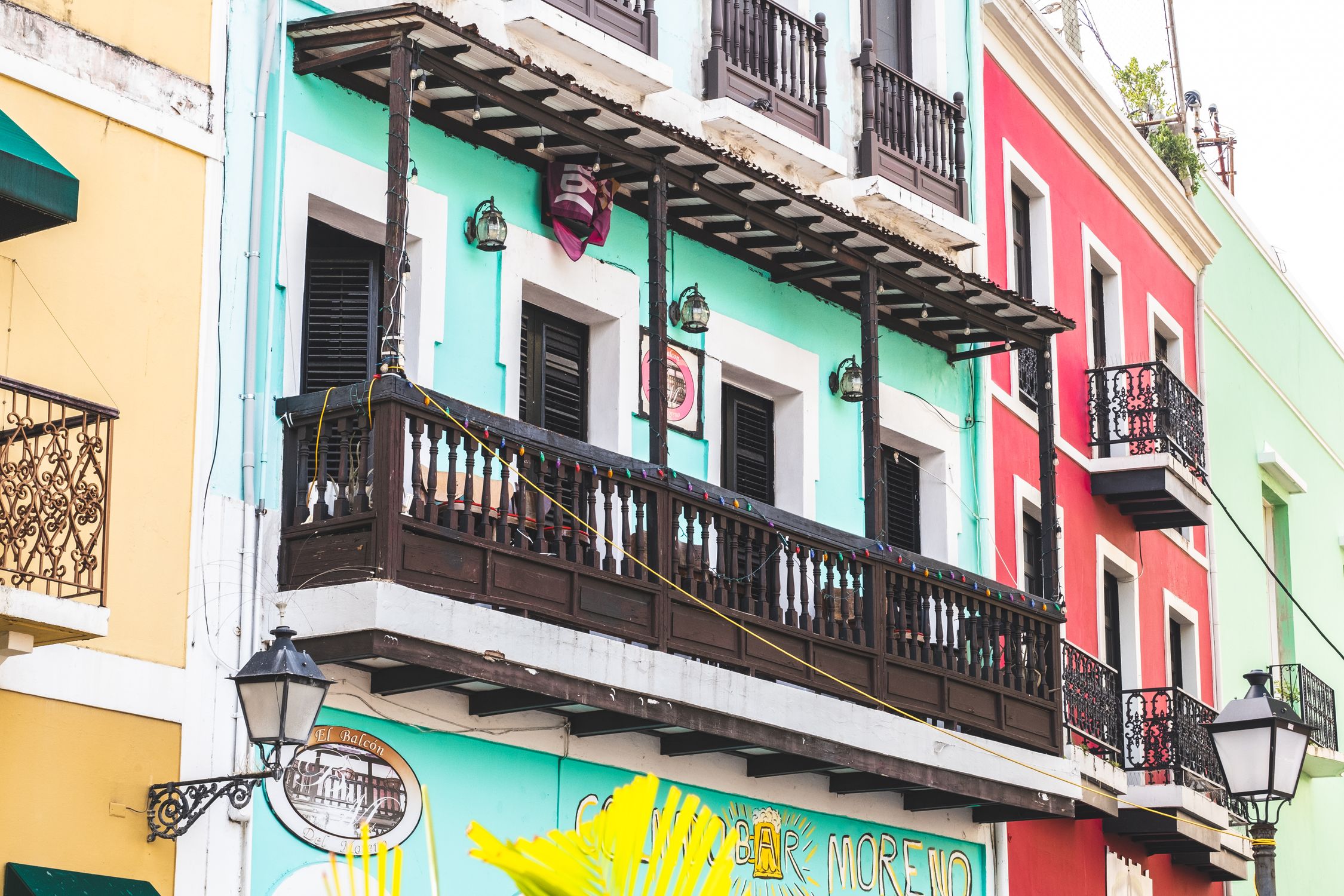 Vibrant colonial-style buildings with wooden balconies in Old San Juan, Puerto Rico.