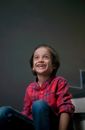 Smiling boy sitting in room