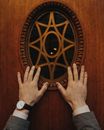 Hands Touching the Oval Shape Glass Pane
