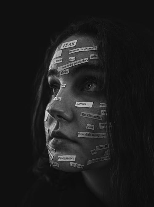 Grayscale Photo of Woman's Face Full of Text