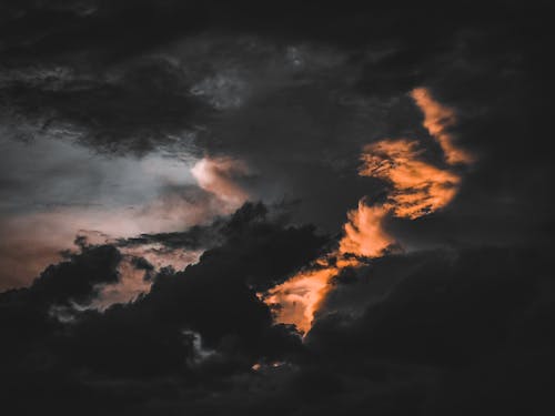 Dramatic dark clouds in sundown sky