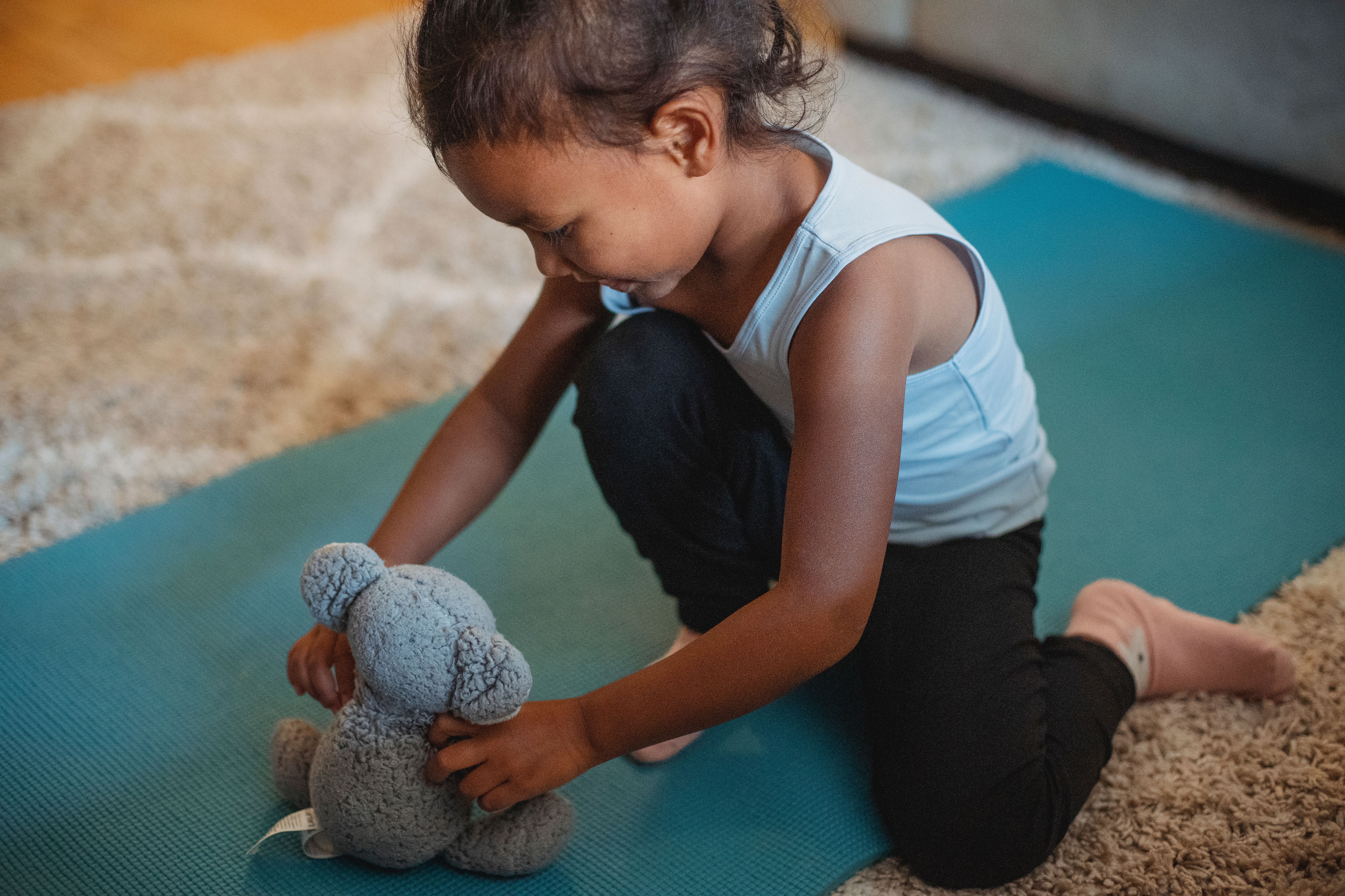 Cute Young Girl Playing with a Stuffed Toy · Free Stock Photo