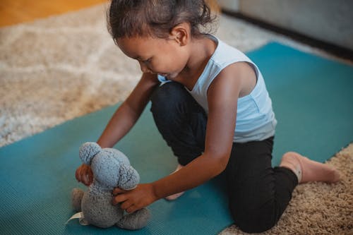Cute Young Girl Playing with a Stuffed Toy