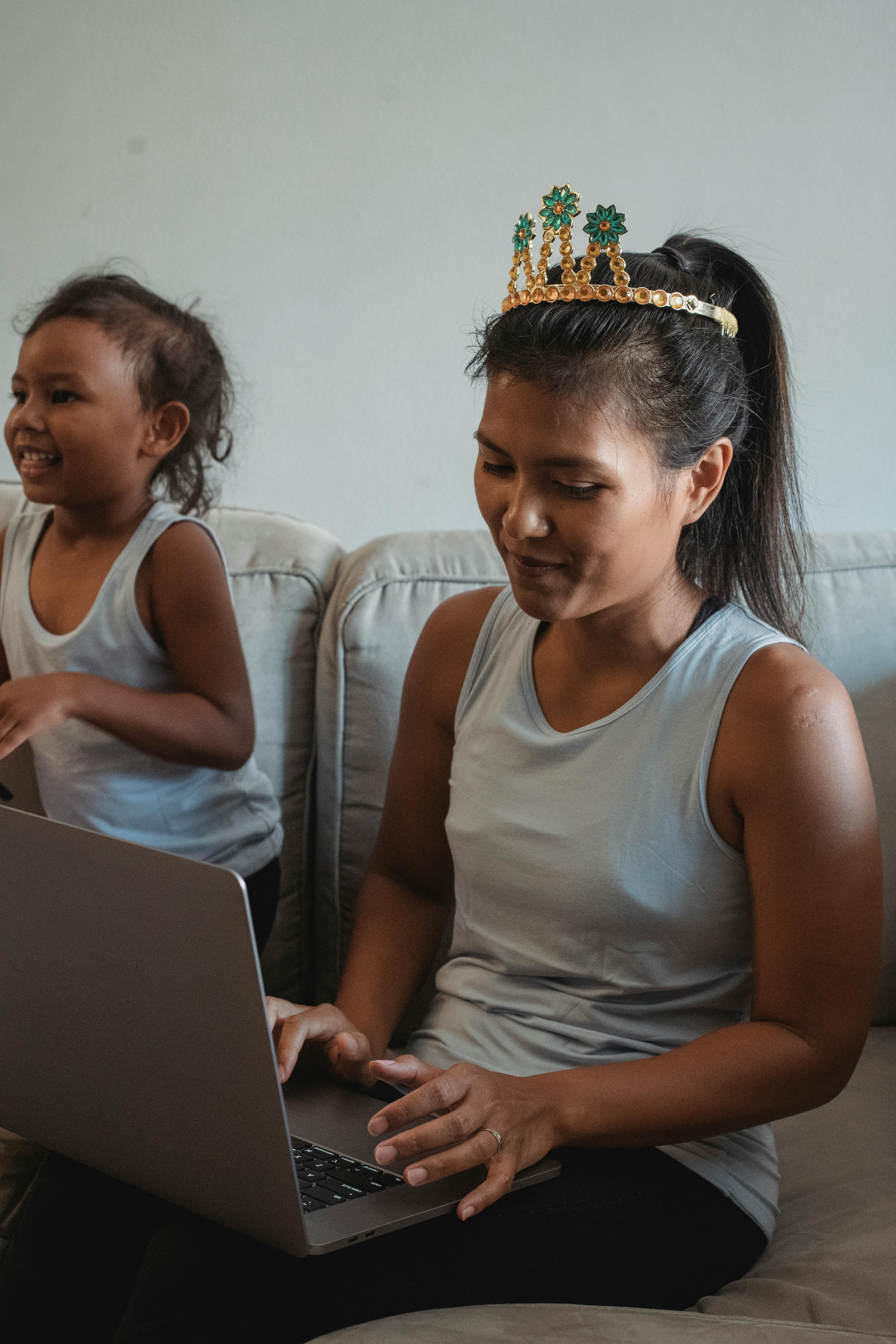 smiling woman using laptop on couch