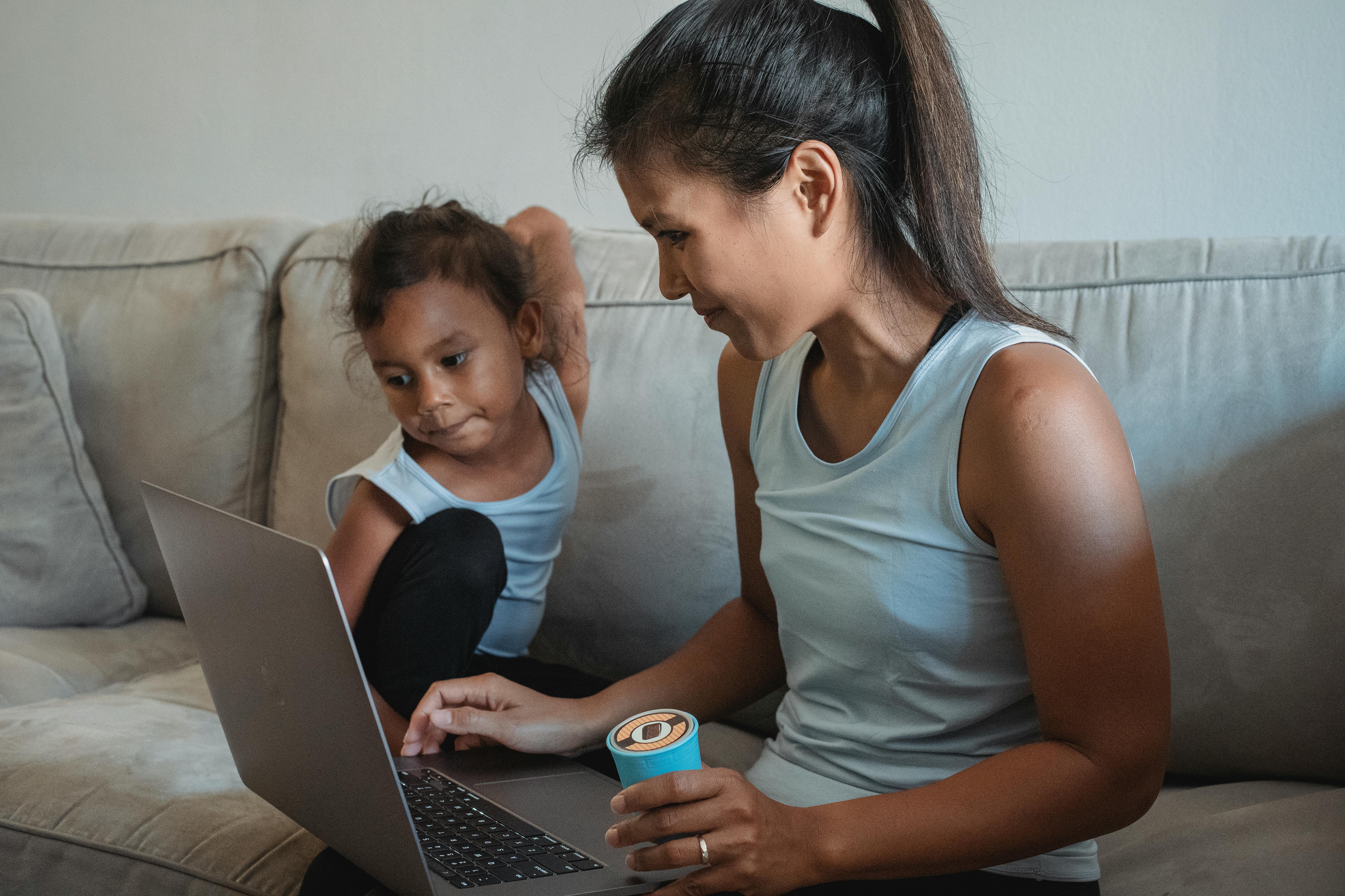 mother and daughter looking at laptop