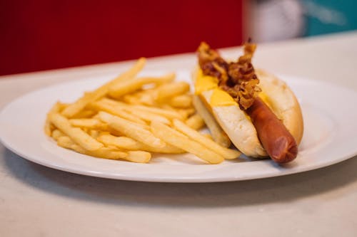Free French Fries and Hotdog Sandwich on White Ceramic Plate Stock Photo
