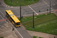 A Long Bus Crossing a Railroad