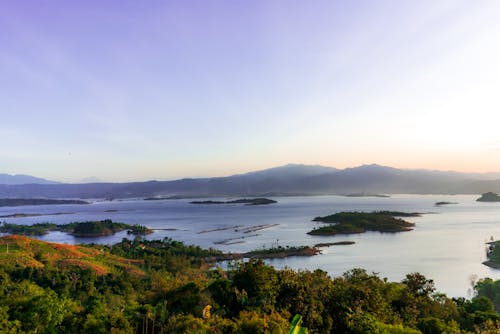 Calm sea surrounded with hills covered with lush tropical vegetation