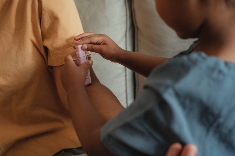 Crop Ethnic Mother And Daughter Playing Doctor