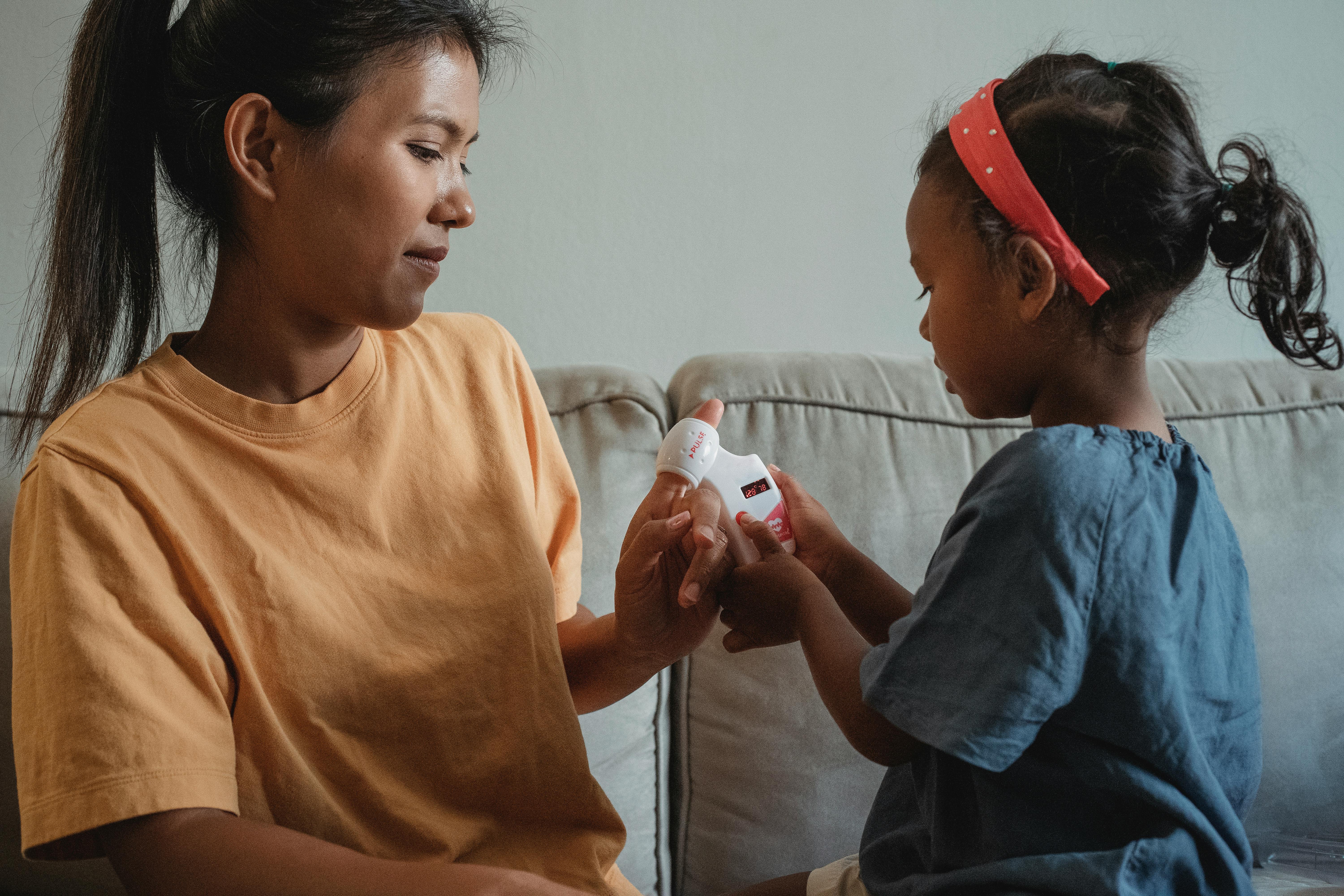 asian mother and daughter playing doctor