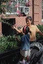 Asian mother and daughter touching blooming tree