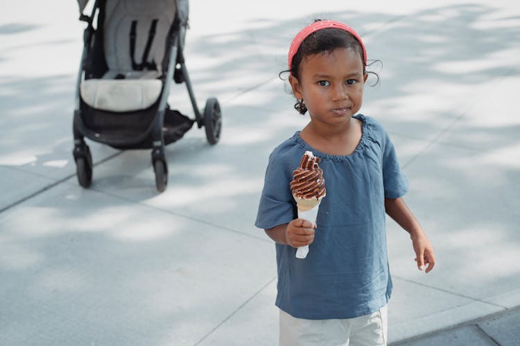 Cute Asian Little Girl Eating Chocolate Sweet Ice Cream