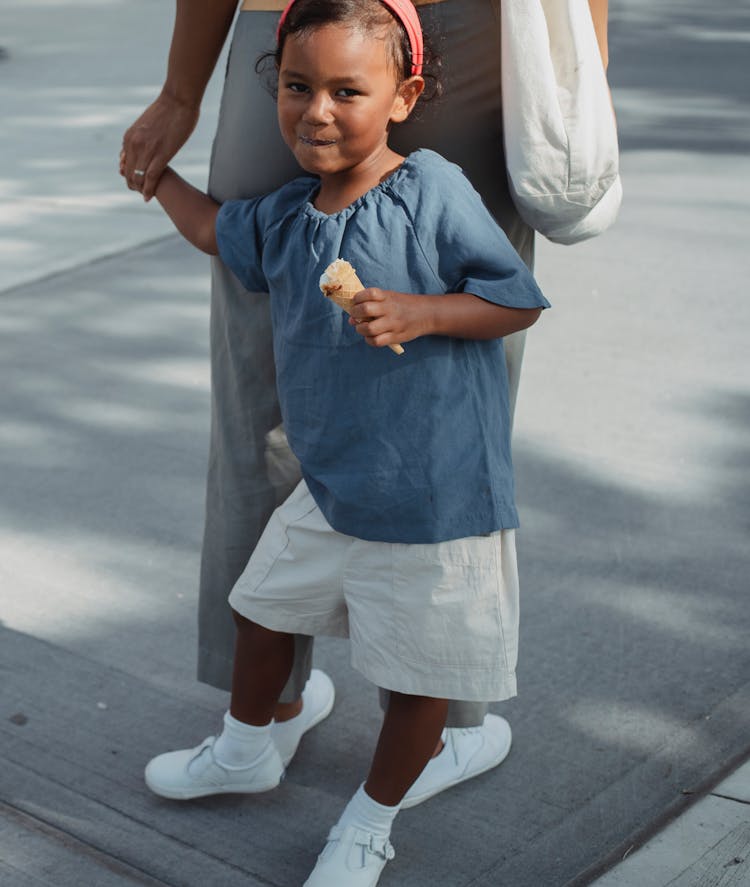 Cheerful Asian Child Standing With Mother And Looking At Camera