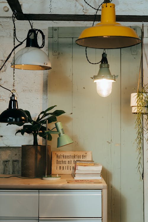 White Pendant Lamps Turned on Near Brown Wooden Shelf