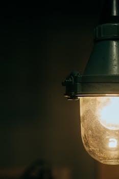 Close-up of a glowing vintage industrial-style hanging lightbulb indoors.