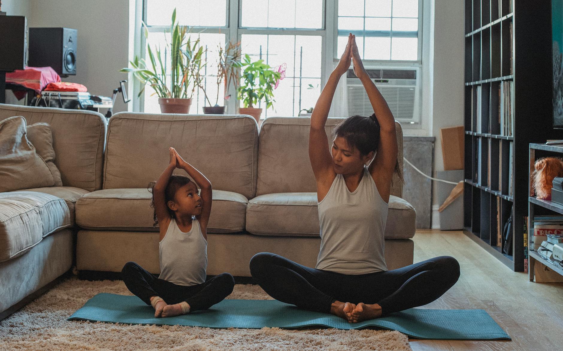 a child doing yoga with mom