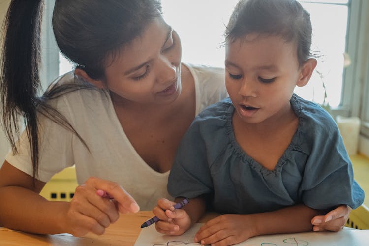 Crop Ethnic Woman And Daughter Drawing Together At Home