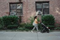 Ethnic woman with baby carriage