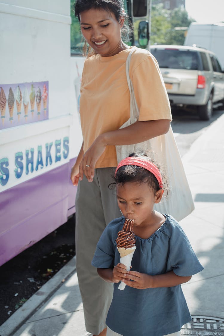 Mother And Daughter Near Ice Cream Truck