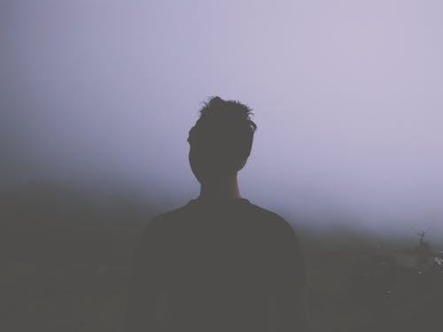 Man Standing Facing White Fogs