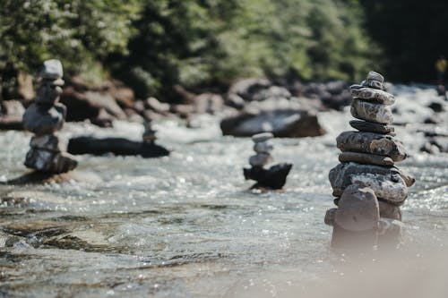 Free Balanced rock zen stack in flowing river Stock Photo