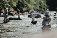 Balanced rock zen stack in flowing river